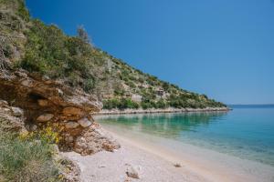 a beach next to the water with a cliff at Hidden Gem by Nono Ban in Bol