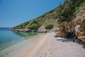 a sandy beach next to the ocean on a hill at Hidden Gem by Nono Ban in Bol