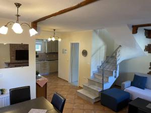 a living room with a staircase and a kitchen at Makis Nest Apart-Hotel in Vourvourou