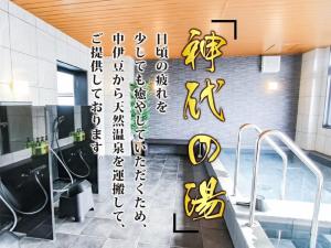 Baño con escritura amarilla en la pared en HOTEL LiVEMAX PREMIUM Umeda EAST en Osaka