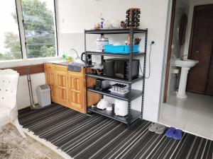 a bathroom with a sink and a shelf at Suva Hideaway Villa in Suva