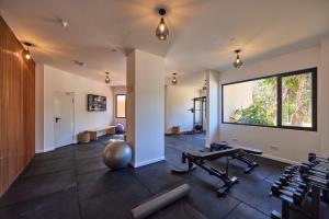 a gym with weights and dumbbells and a large window at tent Palmanova in Palmanova