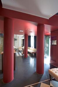 a lobby with red columns in a building at Hotel Piccolo Portofino in Portofino