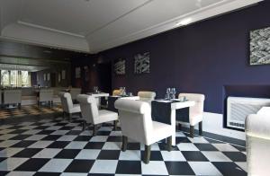 a restaurant with a checkered floor and tables and chairs at Hotel Piccolo Portofino in Portofino