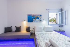 a room with two beds and a window at SantoriniNY in Perissa