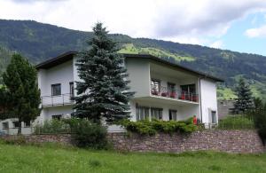 a white house with a tree in front of it at Haus Wieser in Lienz