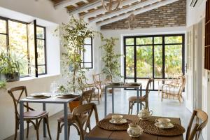 a dining room with tables and chairs and windows at Casale delle Lavande in Citta' Sant'Angelo