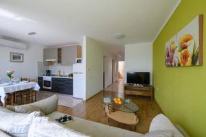 a living room with a couch and a table at Apartment Matej in Rabac