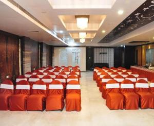 a large room with orange chairs in a room at Simran Heritage(Business Hotel in Raipur
