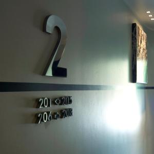 a number on the wall of a bathroom with a thermometer at Hotel Piccolo Portofino in Portofino