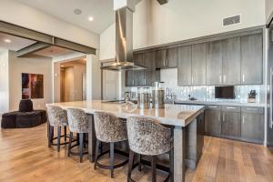 a kitchen with a large island with bar stools at Gorgeous Five Bedroom Penthouse in the Heart of Park City apartment hotel in Park City