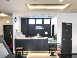 a lobby with a reception desk in a building at HOTEL LiVEMAX PREMIUM Umeda EAST in Osaka
