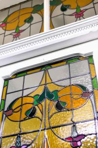 a stained glass window on a wall with oranges at Eaton house in Pembroke