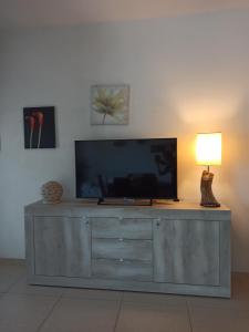 a flat screen tv sitting on top of a dresser at Gio.Ele in Melendugno
