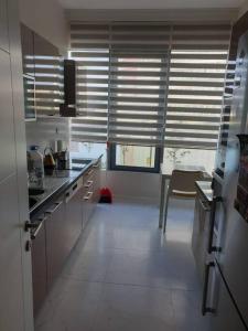 a kitchen with stainless steel appliances and a table at Amazing Apartment in a vibrant Area with Stunning Lake View in Istanbul! in Esenyurt