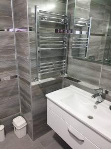 a bathroom with a sink and a shower at Amazing Apartment in a vibrant Area with Stunning Lake View in Istanbul! in Esenyurt