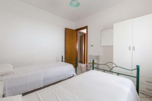 a hospital room with two beds and a cabinet at Case al Tacco di Leuca in Marina di Leuca