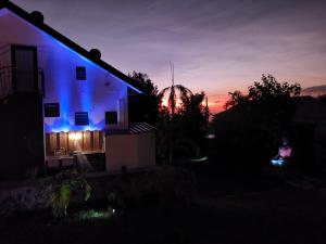 a house with blue lights on the side of it at night at Hostal 170 Room 15 Service Appartement in Le Tampon