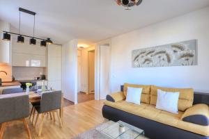 a living room with a couch and a dining room at Barbara with private parking in the garage in Zadar