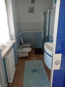 a bathroom with two toilets and a sink and a shower at CASA VACANZE RELAX in Riva di Solto