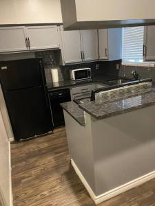 a kitchen with white cabinets and a counter top at Huge one bedroom with 2 Queen size beds in Houston