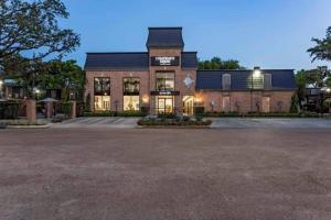 a large brick building with a dark roof at Huge one bedroom with 2 Queen size beds in Houston