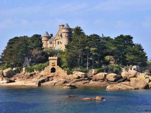 ein Schloss auf einer Insel im Wasser in der Unterkunft Maison 3* avec Terrasse, Confort Moderne, Proche Plages et Randonnées - FR-1-542-53 in Trégastel
