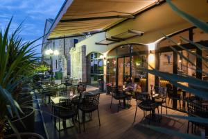 a restaurant with chairs and tables on a patio at Teatro Verdi Boutique Hotel in Zadar