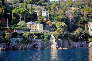 a village on the shore of a body of water at Hotel Piccolo Portofino in Portofino