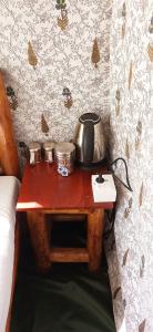 a table with a tea pot and pans on it at Corbett Nature Retreat in Rāmnagar