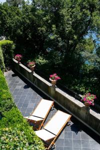 a group of chairs and flowers on a patio at Hotel Piccolo Portofino in Portofino