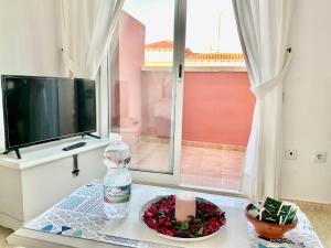 a living room with a table with a candle and a television at Torremar Natura Julia in Vera