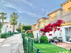 a house with red flowers on the side of it at Torremar Natura Julia in Vera