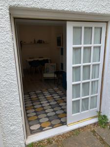 a door into a room with a checkered floor at Beachside - North Berwick in North Berwick