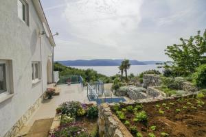a house with a garden and a view of the water at Villa Paradiso in Plomin - Istrien in Plomin