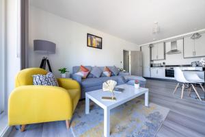 a living room with a yellow couch and a table at Ash View Place 3 -Heathrow - Thorpe Park - Free Parking in Staines