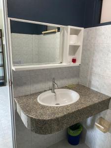 a bathroom counter with a sink and a mirror at Hotel Kata Hill Sea View in Kata Beach