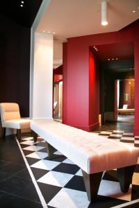 a bench in a room with red walls and a checkered floor at Hotel Piccolo Portofino in Portofino