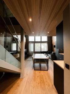 a kitchen and dining room with a table in a room at Levin Kunkku B penthouse in Levi