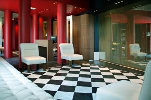 a waiting room with chairs and a checkered floor at Hotel Piccolo Portofino in Portofino