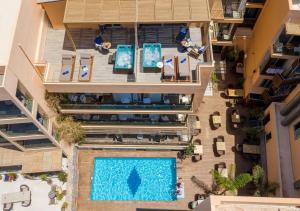 an overhead view of a swimming pool in a building at Palmera Beach Hotel & Spa - Adults Only in Hersonissos