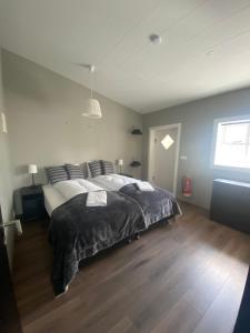 a bedroom with a large bed and a window at Beautiful house with amazing sea view. in Dalvík