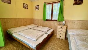 Postel nebo postele na pokoji v ubytování Chatový areál ATLAS