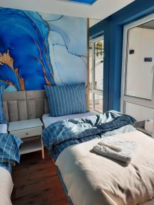 a bedroom with a bed with a mural on the wall at Nadmorski Bursztyn in Rowy