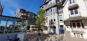 a city street with bikes parked next to a building at Le Petit Nord in De Panne