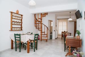 a dining room with a table and chairs at Smaragdi - Naxian traditional house with panoramic view at Eggares village in Engares