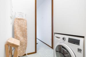 een wasruimte met een wasmachine en een kruk bij San Vicente 31 Old Town in Benidorm