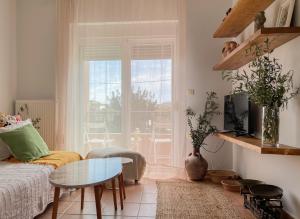 a living room with a couch and a table at Casa Verde Houses in Kos