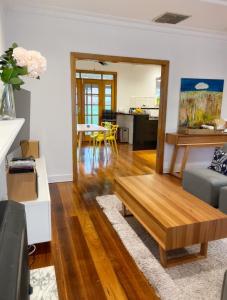 uma sala de estar com um sofá e uma mesa de centro em Cozy and stylish 3 bedroom home in Mentone em Mentone