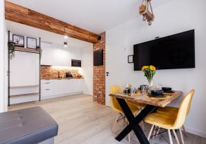 a kitchen and dining room with a table and chairs at Apartamenty Gdansk EU - Angielska Grobla II OLD TOWN Gdańsk Angielska Grobla 5 in Gdańsk